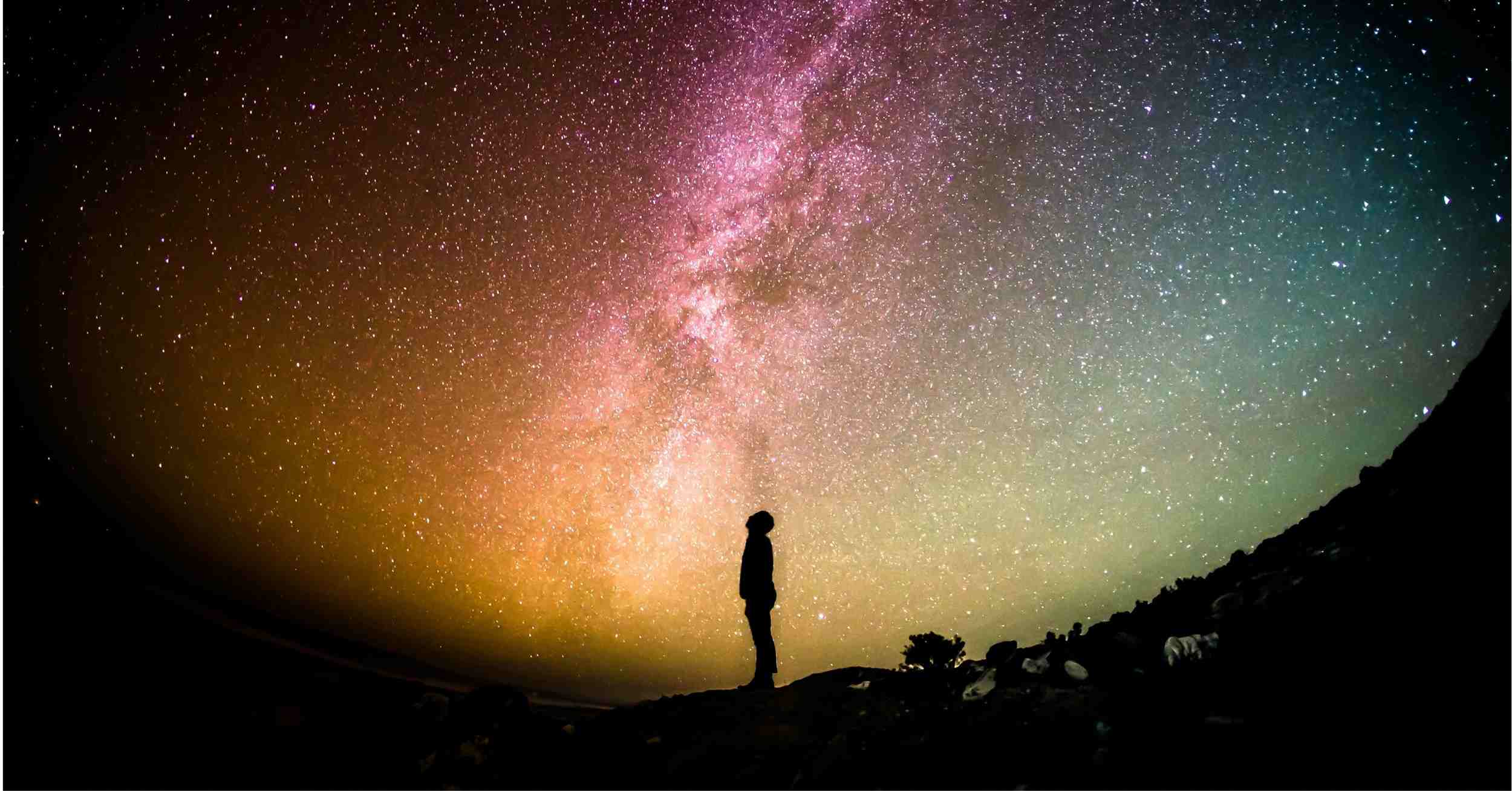 Person standing under a starry night sky — Taking the Mystery Out of Meditation